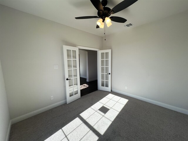 unfurnished bedroom with french doors, dark carpet, baseboards, and ceiling fan
