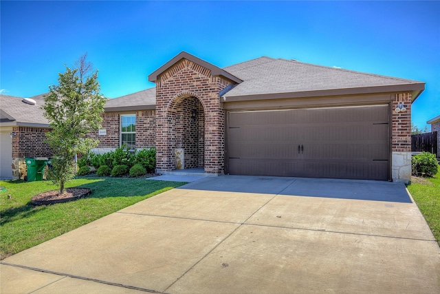 2229 Darner Dr, Fate, TX 75189 - view of front facade featuring brick siding, a shingled roof, a garage, and driveway