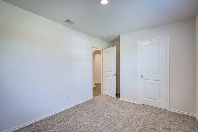2229 Darner Dr, Fate, TX 75189 - unfurnished bedroom featuring light carpet, baseboards, and arched walkways