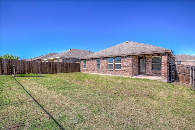 2229 Darner Dr, Fate, TX 75189 - rear view of house with brick siding, a patio, and roof with shingles