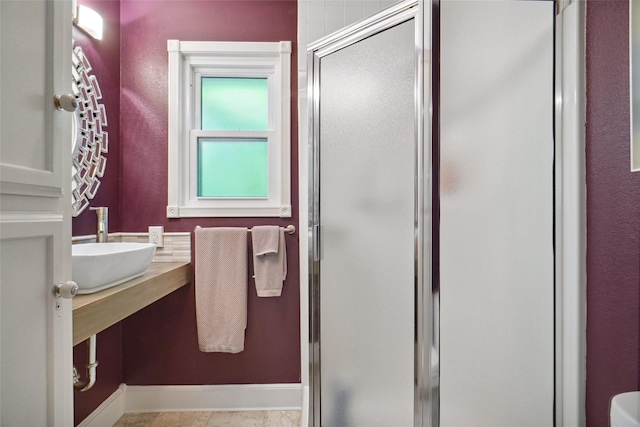 1010 Kings Canyon Ct, Grapevine, TX 76051 - bathroom featuring a sink, a stall shower, and baseboards