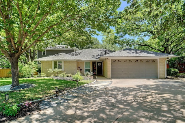 1010 Kings Canyon Ct, Grapevine, TX 76051 - view of front facade with a garage, concrete driveway, brick siding, and roof with shingles