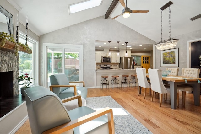 1010 Kings Canyon Ct, Grapevine, TX 76051 - dining area with high vaulted ceiling, light wood-style flooring, a skylight, a ceiling fan, and beam ceiling