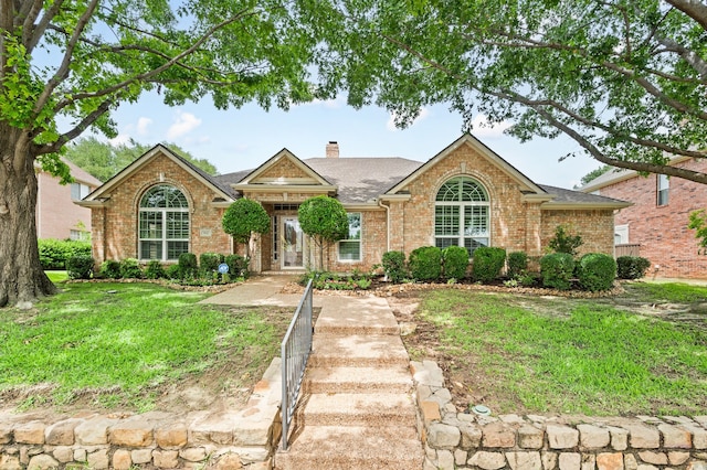 904 Blue Jay Ln, Coppell, TX 75019 - view of front of home featuring brick siding, a chimney, a front lawn, and roof with shingles