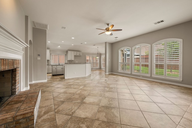 904 Blue Jay Ln, Coppell, TX 75019 - unfurnished living room featuring ceiling fan, healthy amount of natural light, a fireplace, baseboards, and recessed lighting