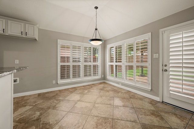 904 Blue Jay Ln, Coppell, TX 75019 - unfurnished dining area with baseboards, lofted ceiling, and light tile patterned floors