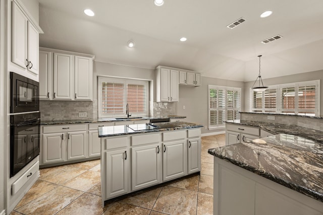 904 Blue Jay Ln, Coppell, TX 75019 - kitchen featuring black appliances, a sink, decorative backsplash, white cabinets, and lofted ceiling