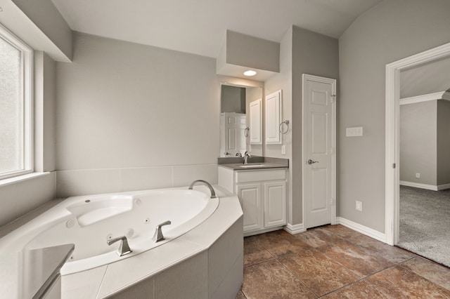 904 Blue Jay Ln, Coppell, TX 75019 - bathroom with a whirlpool tub, vanity, and baseboards