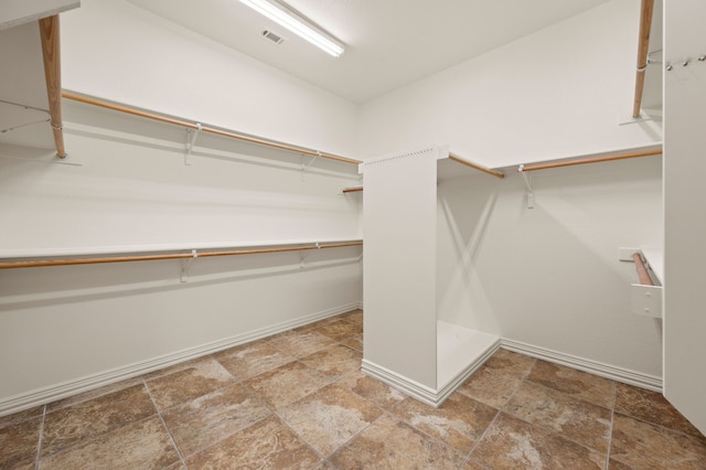 904 Blue Jay Ln, Coppell, TX 75019 - spacious closet with stone finish floors