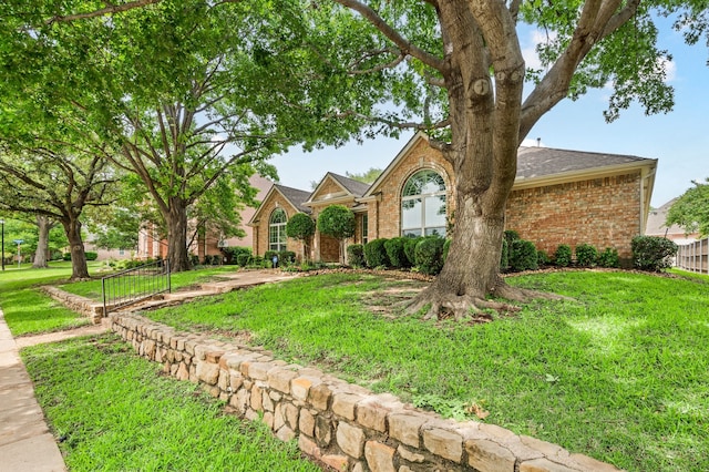904 Blue Jay Ln, Coppell, TX 75019 - view of front facade with brick siding, a front lawn, and roof with shingles