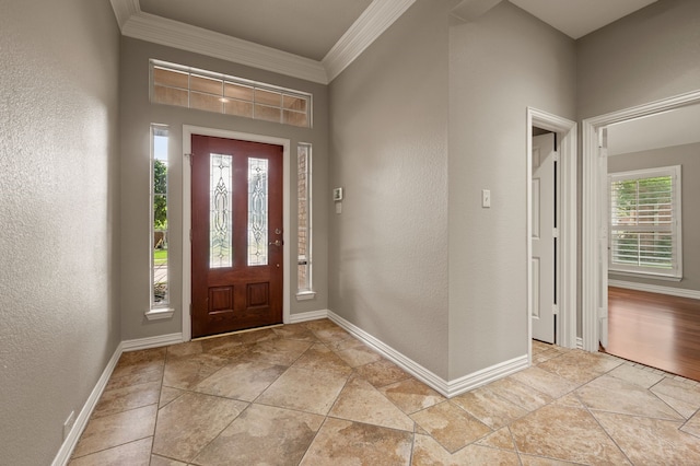 904 Blue Jay Ln, Coppell, TX 75019 - foyer with baseboards, crown molding, light stone finish floors, and a textured wall