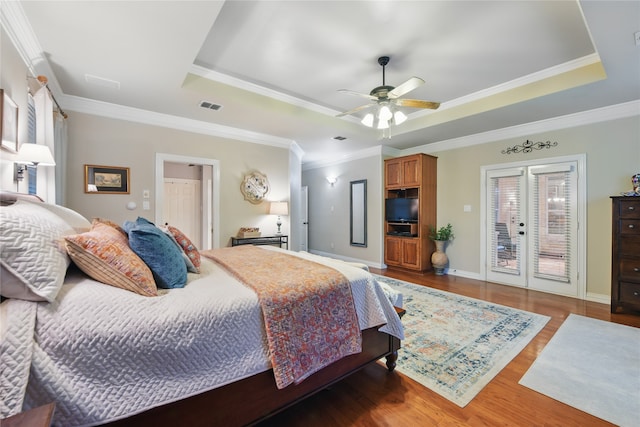 4019 Brooks Ct, Highland Village, TX 76226 - bedroom featuring a raised ceiling, french doors, wood finished floors, access to exterior, and ornamental molding