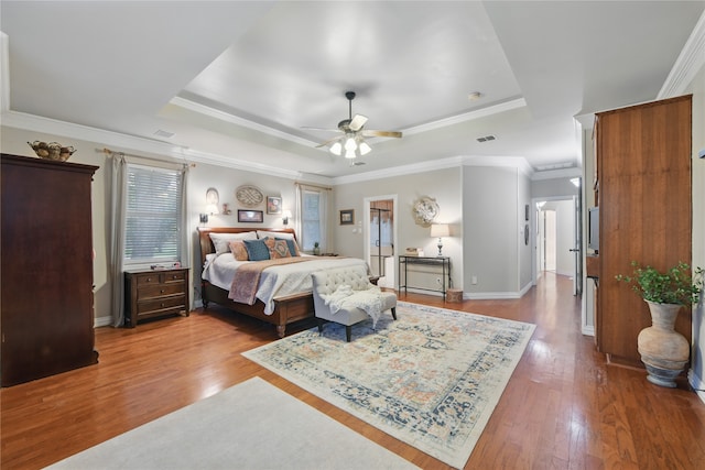 4019 Brooks Ct, Highland Village, TX 76226 - bedroom with a tray ceiling, wood finished floors, ornamental molding, and baseboards