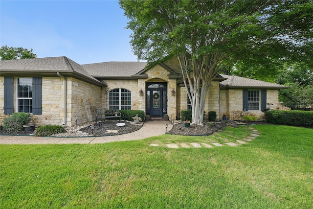 4019 Brooks Ct, Highland Village, TX 76226 - view of front of home with stone siding, a shingled roof, and a front yard
