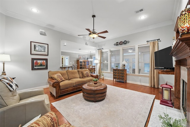 4019 Brooks Ct, Highland Village, TX 76226 - living room featuring ceiling fan, a fireplace with flush hearth, ornamental molding, light wood-style flooring, and baseboards