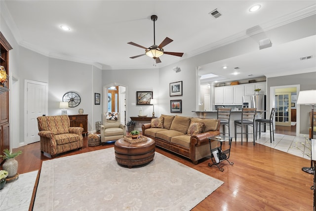 4019 Brooks Ct, Highland Village, TX 76226 - living area featuring arched walkways, a ceiling fan, crown molding, light wood-style floors, and recessed lighting