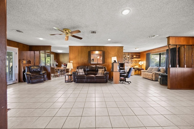 150 N Powell Dr, Hubbard, TX 76648 - living room featuring wood walls, a textured ceiling, ceiling fan, light tile patterned floors, and recessed lighting