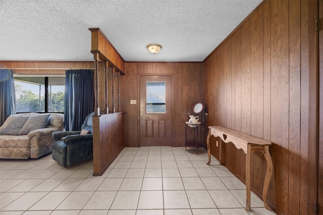 150 N Powell Dr, Hubbard, TX 76648 - entryway featuring wood walls, a textured ceiling, and light tile patterned floors