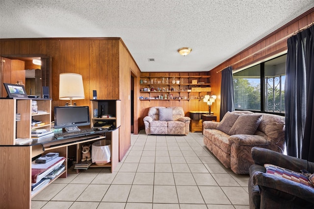 150 N Powell Dr, Hubbard, TX 76648 - living area with wooden walls, a textured ceiling, built in features, light tile patterned flooring, and ornamental molding