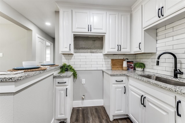 437 22nd St, Grand Prairie, TX 75050 - kitchen featuring a sink, dark wood-style floors, white cabinets, decorative backsplash, and recessed lighting