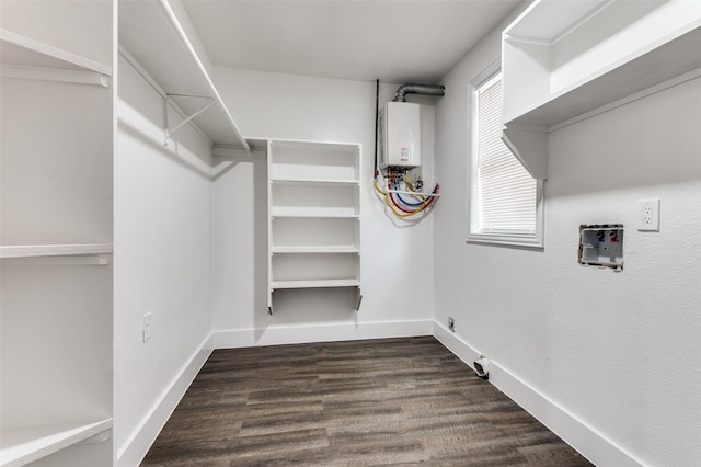 437 22nd St, Grand Prairie, TX 75050 - spacious closet featuring tankless water heater and dark wood-type flooring