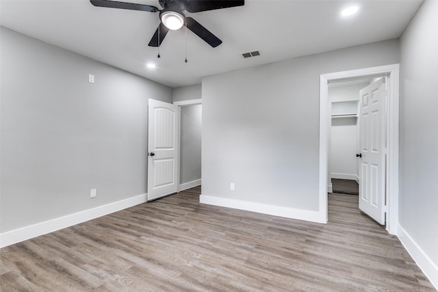 437 22nd St, Grand Prairie, TX 75050 - unfurnished bedroom with wood finished floors, recessed lighting, a spacious closet, baseboards, and a ceiling fan