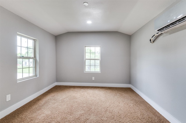 437 22nd St, Grand Prairie, TX 75050 - empty room featuring plenty of natural light, a wall mounted AC, lofted ceiling, carpet floors, and baseboards