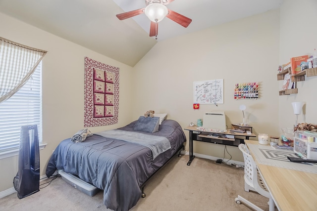bedroom with light carpet, lofted ceiling, baseboards, and a ceiling fan