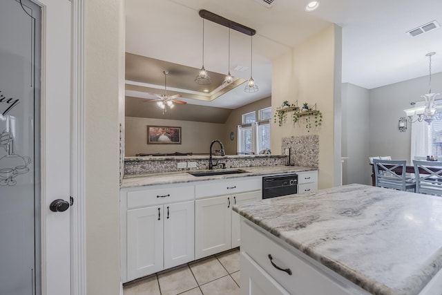 kitchen featuring a sink, white cabinetry, light stone counters, light tile patterned floors, and a ceiling fan