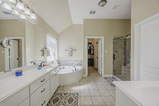 full bathroom featuring vanity, a stall shower, tile patterned floors, a walk in closet, and a bath