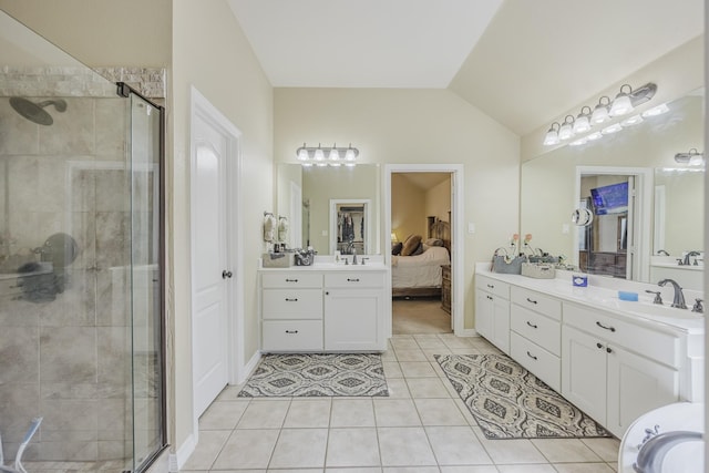 bathroom featuring a shower stall, tile patterned flooring, lofted ceiling, vanity, and ensuite bath