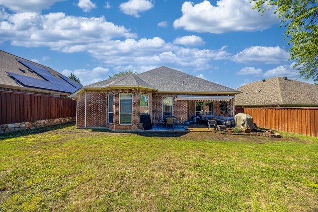 back of house with a patio, brick siding, and a shingled roof