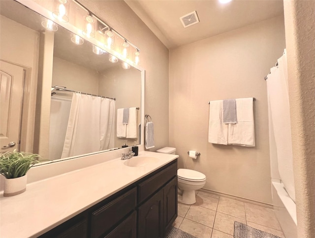 bathroom with vanity, tile patterned flooring, and toilet