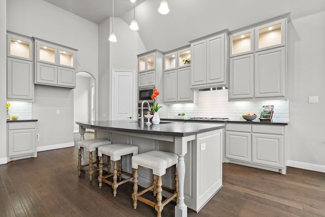 720 Waterbrook Pkwy, Argyle, TX 76226 - kitchen featuring dark countertops, a sink, stainless steel appliances, tasteful backsplash, and dark wood-style flooring