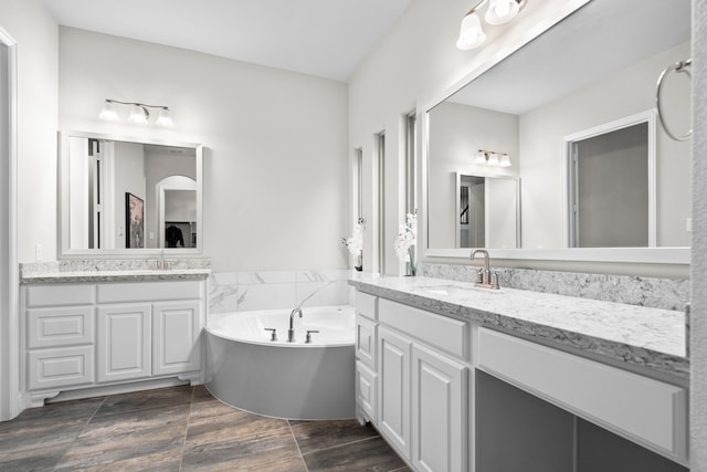 720 Waterbrook Pkwy, Argyle, TX 76226 - full bathroom featuring a bath, two vanities, and wood finished floors
