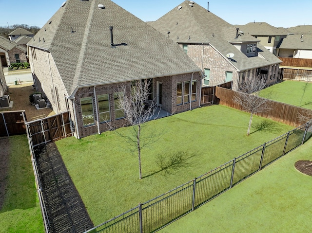 720 Waterbrook Pkwy, Argyle, TX 76226 - back of house featuring a shingled roof, brick siding, and central air condition unit