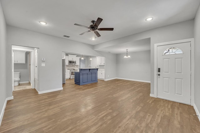 1213 E Laurel St, Tyler, TX 75702 - unfurnished living room with a ceiling fan, baseboards, wood finished floors, and recessed lighting