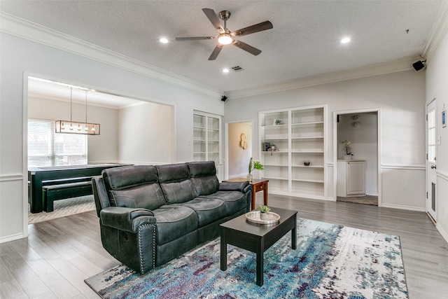 3616 Rolling Meadows Dr, Bedford, TX 76021 - living area with ceiling fan, crown molding, a textured ceiling, wood finished floors, and a chandelier