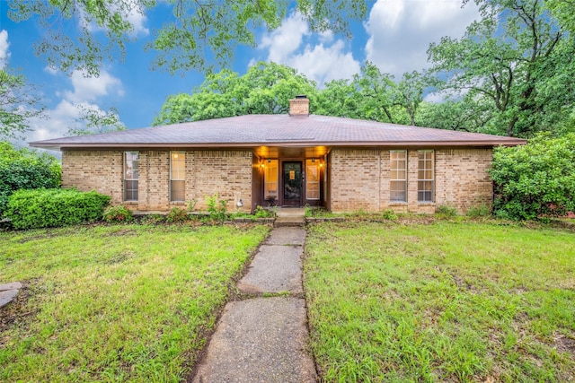 2708 Winchester Ct, Denton, TX 76209 - ranch-style house with a front lawn, a chimney, and brick siding