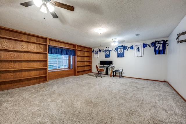 2708 Winchester Ct, Denton, TX 76209 - living area featuring a textured ceiling, a desk, carpet flooring, a ceiling fan, and baseboards