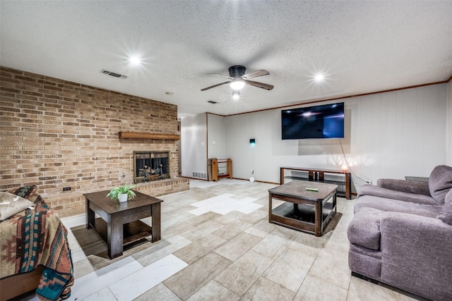 2708 Winchester Ct, Denton, TX 76209 - living room with ceiling fan, a fireplace, a textured ceiling, recessed lighting, and baseboards