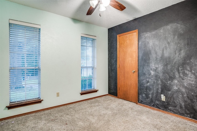 2708 Winchester Ct, Denton, TX 76209 - carpeted spare room featuring ceiling fan, a textured ceiling, and baseboards