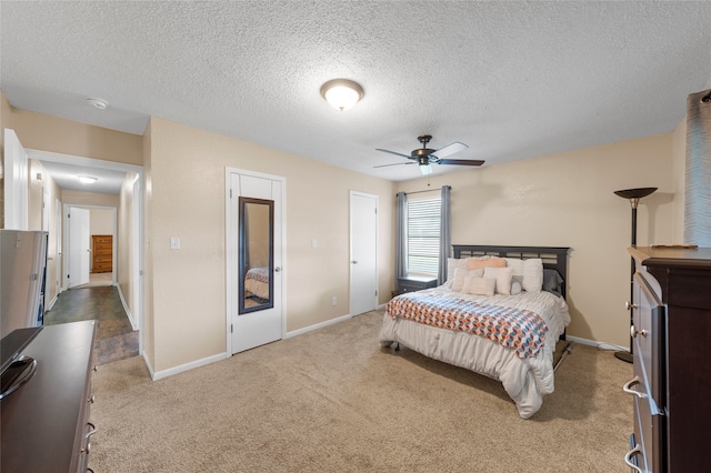 163 Private Road 605, Marlin, TX 76661 - bedroom featuring a textured ceiling, carpet flooring, baseboards, and a ceiling fan