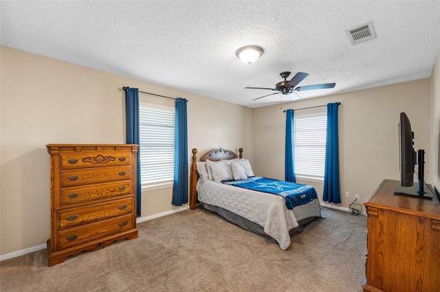163 Private Road 605, Marlin, TX 76661 - bedroom featuring carpet floors, a textured ceiling, baseboards, and a ceiling fan
