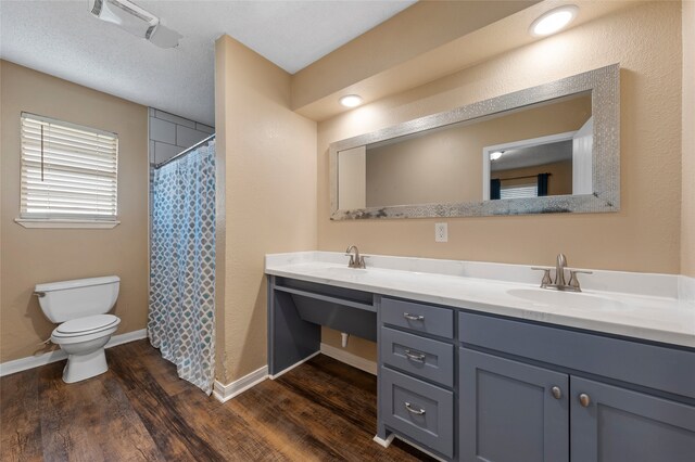 163 Private Road 605, Marlin, TX 76661 - full bath with toilet, wood finished floors, double vanity, baseboards, and a shower with shower curtain