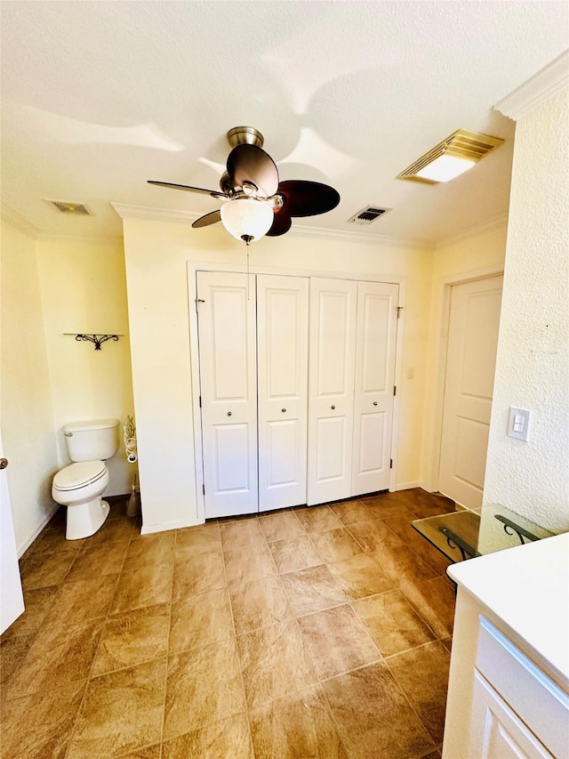408 Briarwood Dr, Eastland, TX 76448 - unfurnished bedroom featuring ornamental molding, a closet, ensuite bathroom, and a ceiling fan