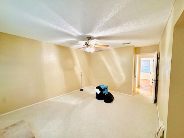408 Briarwood Dr, Eastland, TX 76448 - empty room with carpet floors, baseboards, ceiling fan, and a textured ceiling