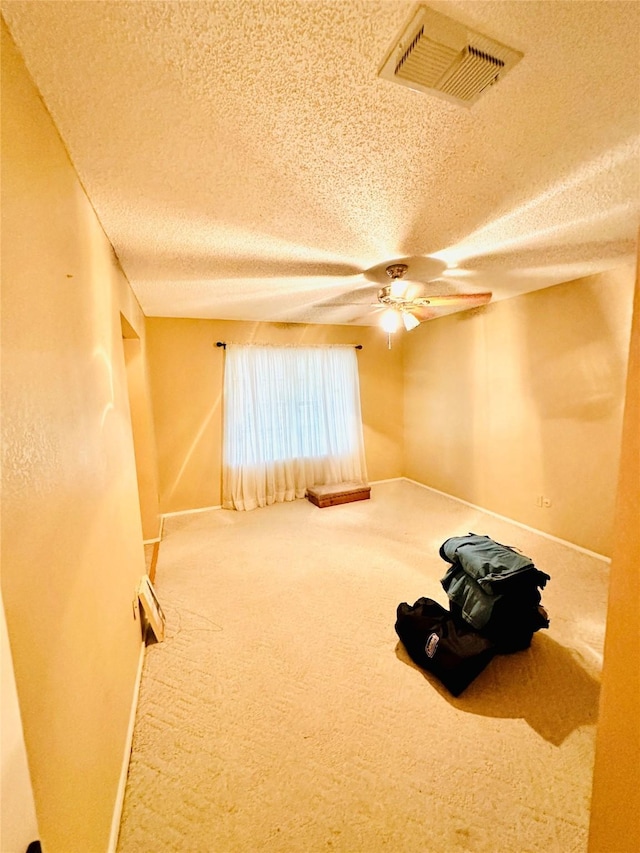 408 Briarwood Dr, Eastland, TX 76448 - carpeted empty room featuring a textured ceiling, baseboards, and ceiling fan