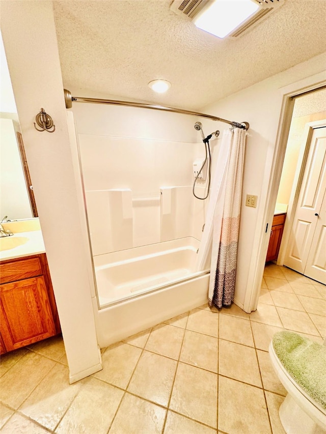 408 Briarwood Dr, Eastland, TX 76448 - full bathroom featuring a textured ceiling, shower / bath combo with shower curtain, tile patterned floors, vanity, and toilet