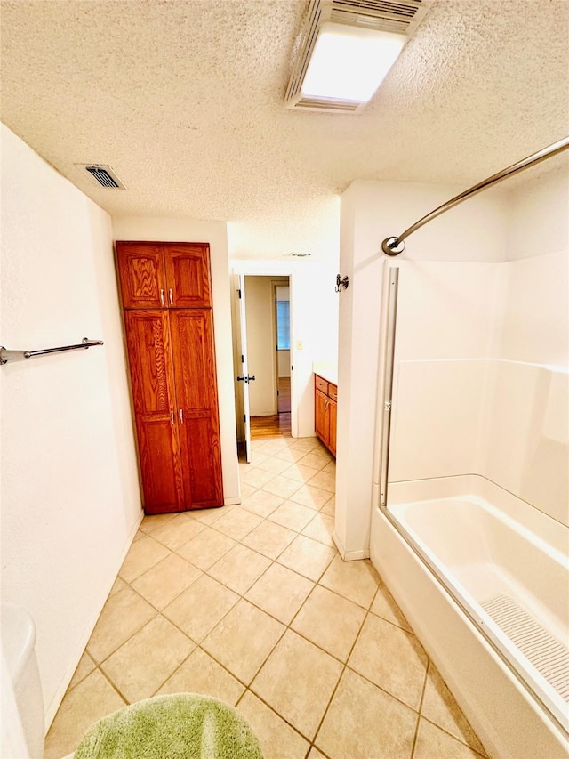 408 Briarwood Dr, Eastland, TX 76448 - bathroom featuring tile patterned floors, tub / shower combination, and a textured ceiling